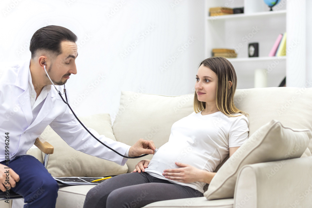 Fototapeta premium Photo of doctor with stethoscope going to exam the pregnant woman.