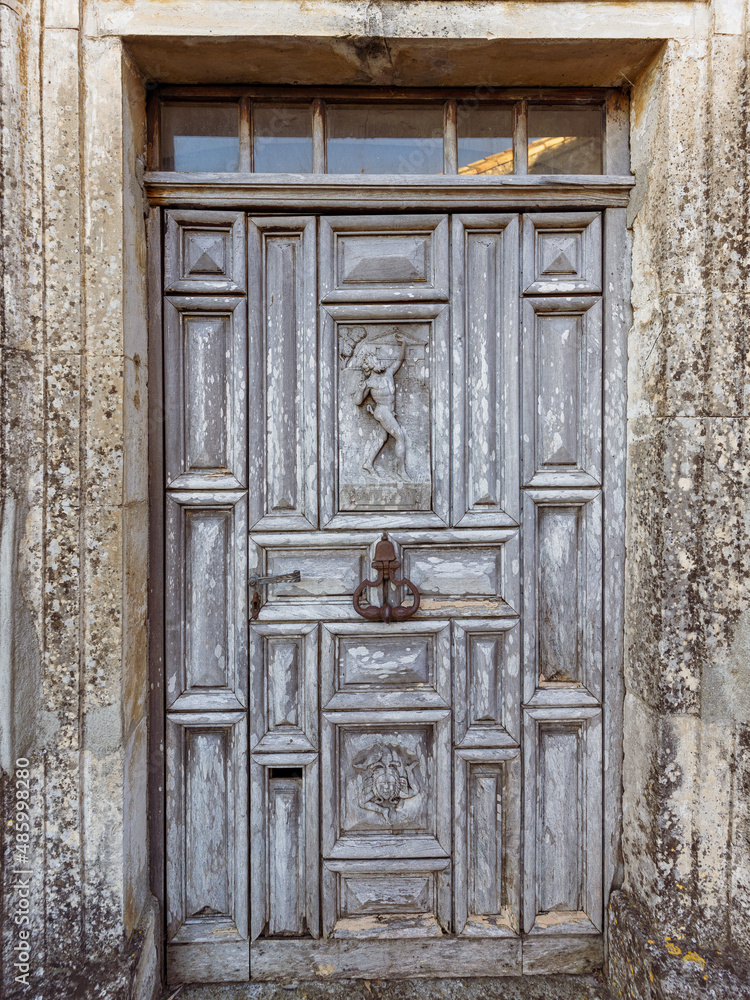 Antique carved wooden door in a medieval village in the South of France