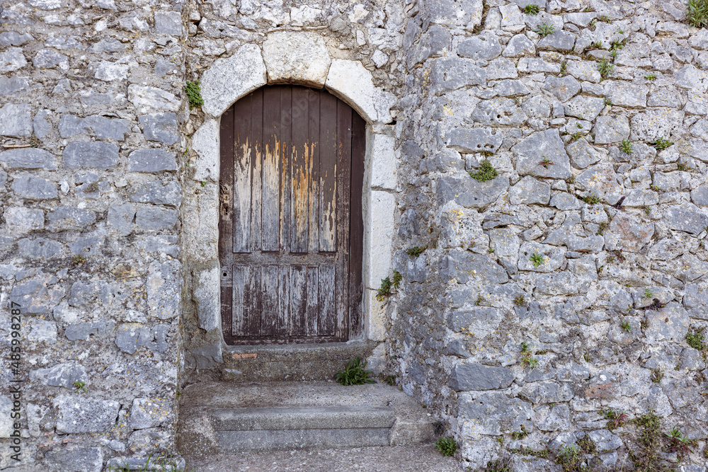 Antique carved wooden door in a medieval village in the South of France Antique carved wooden door in a medieval village in the South of France