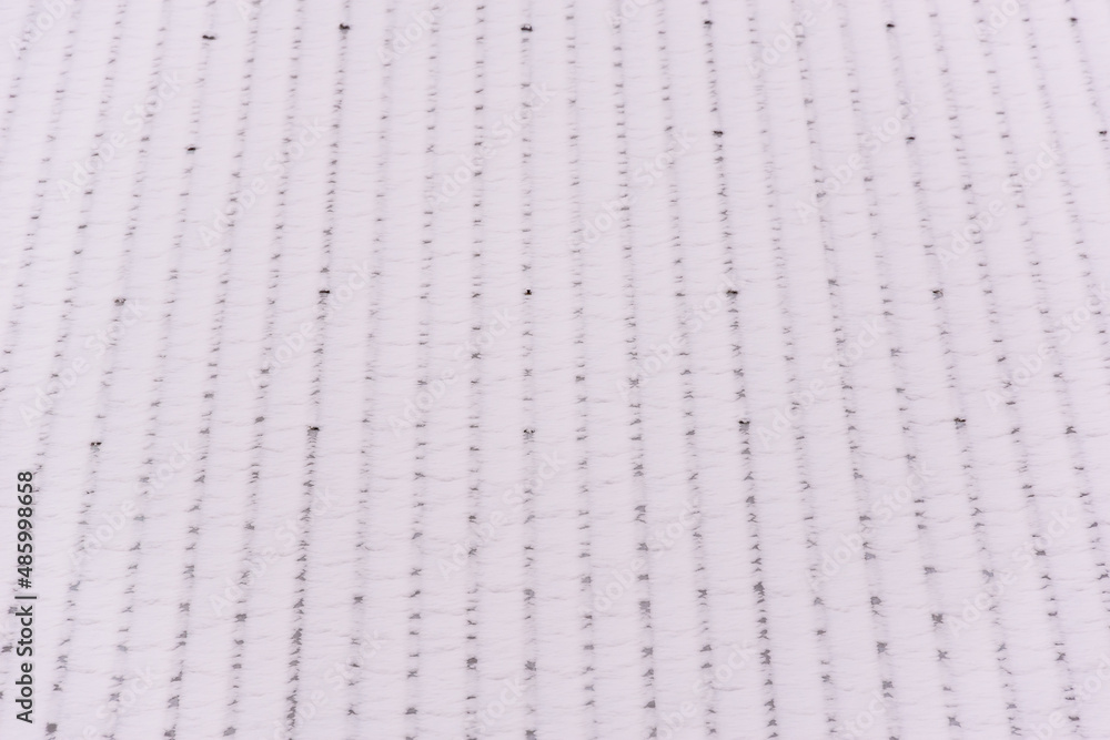 There is fluffy snow on the roof of the house. There is fluffy snow on the roof of the house.