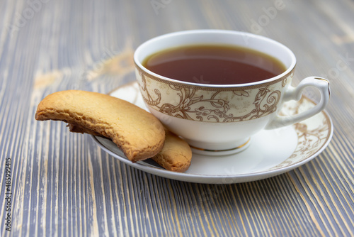 Homemade cookies on a saucer with a cup.