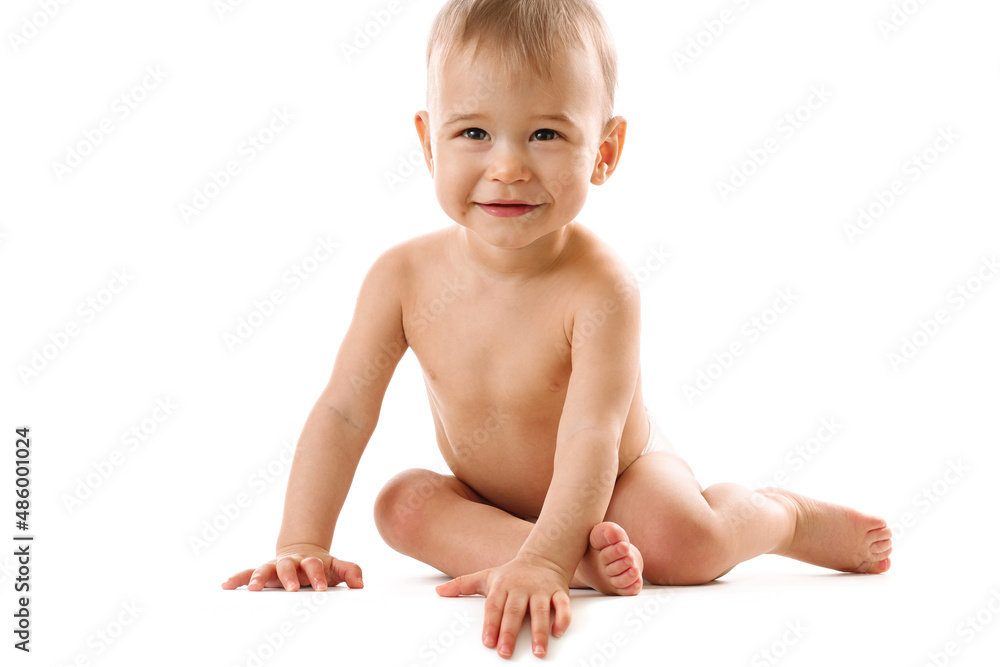 Curious healthy little boy in diaper sitting and smiling. Curious healthy little boy in diaper sitting and smiling.