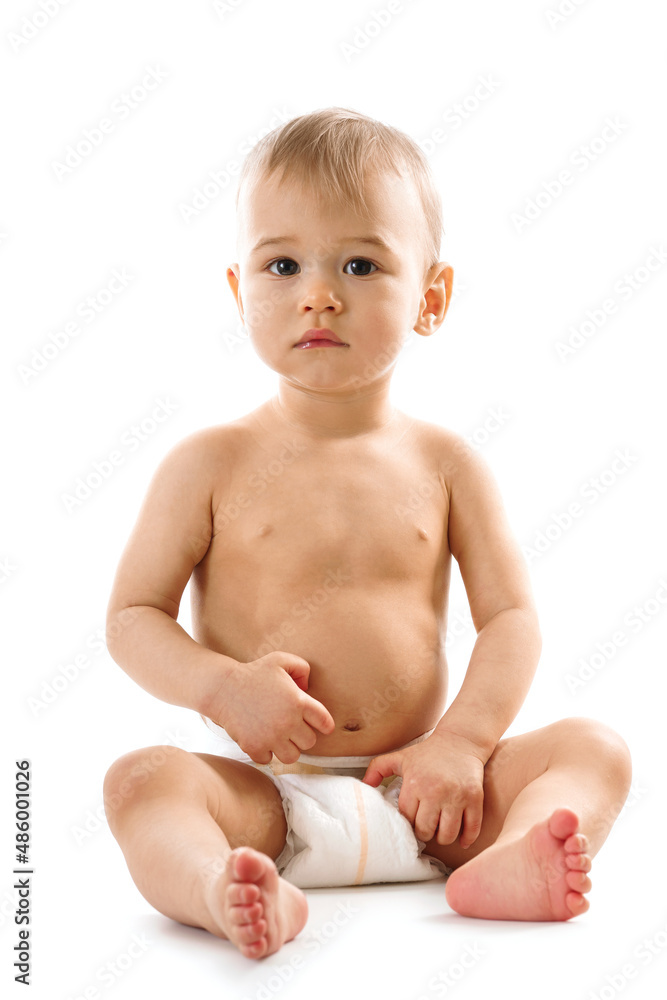 Curious healthy little boy in diaper sitting and looking. Curious healthy little boy in diaper sitting and looking.
