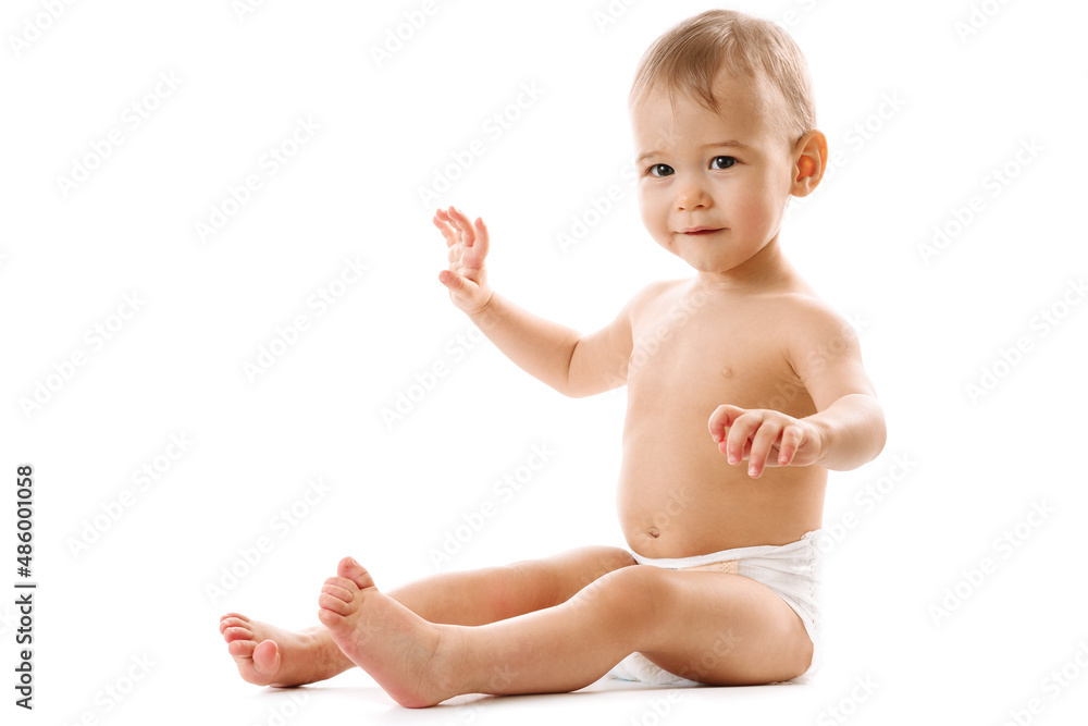 Curious healthy little boy in diaper sitting and smiling. Curious healthy little boy in diaper sitting and smiling.