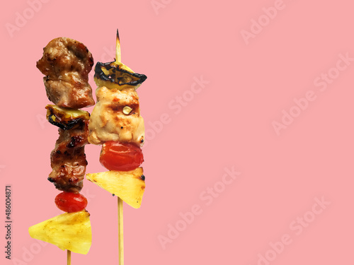 Thai street food fried skewer of pork and sauce with vegetables isolated on pastel color background and copy space for text concept for article and website and menu.