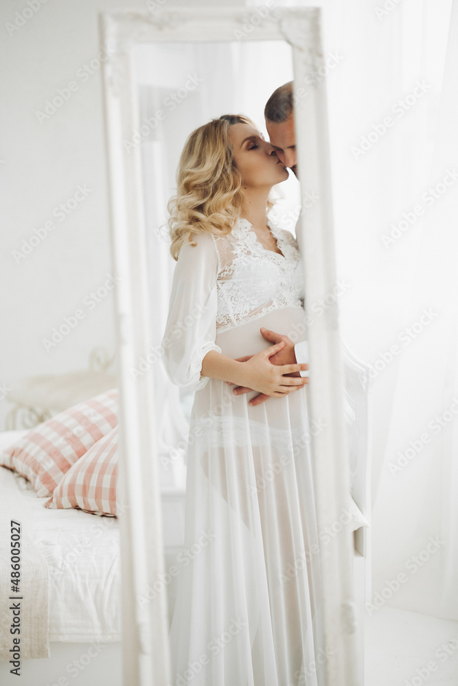 Beautiful couple embracing stomach and touching face to face. Beautiful couple embracing stomach and touching face to face.