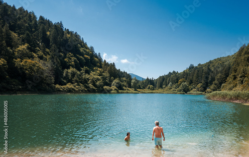 Father with son having fun in lake against sky © bruno135_406