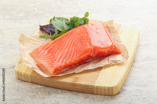 Raw salmon fillet over board