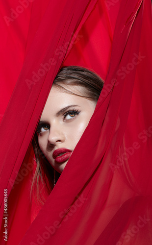 Portrait of young woman wrapped in red cloth.