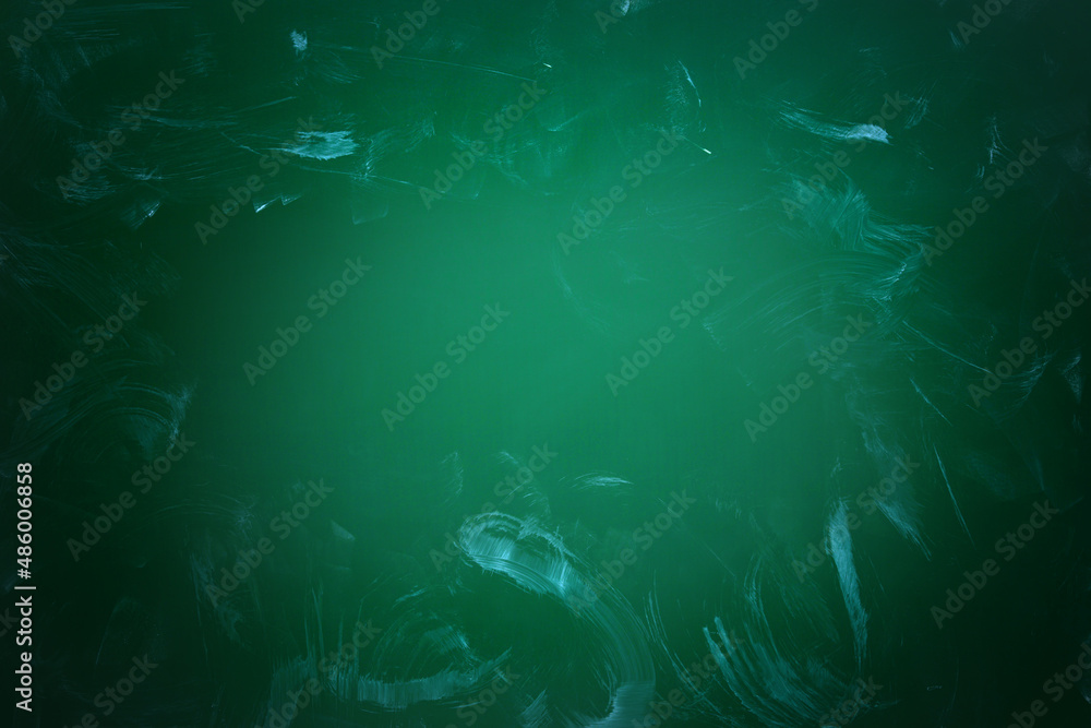 Fototapeta premium Dirty green chalkboard as background. Vignette effect