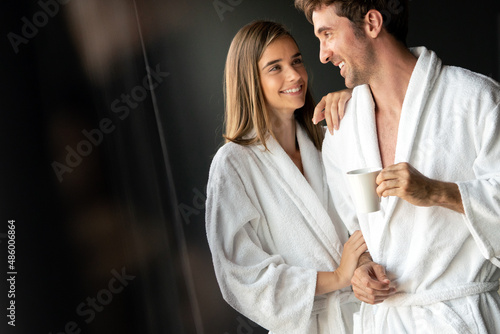 Couple in bathrobes enjoying honeymoon in spa resort