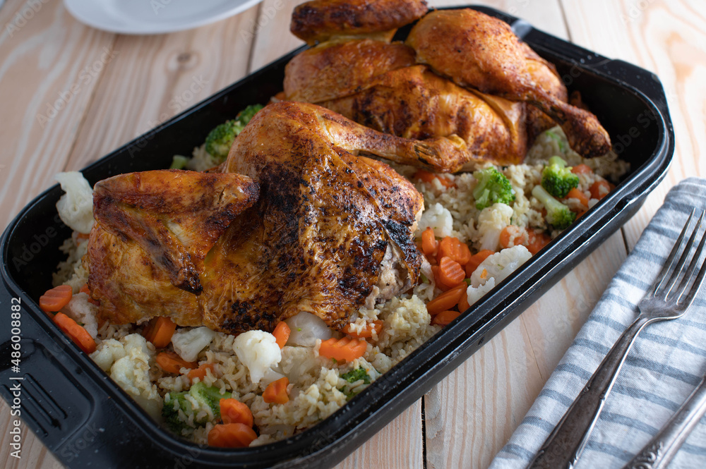 Fototapeta premium Roasted chicken with brown rice and vegetables