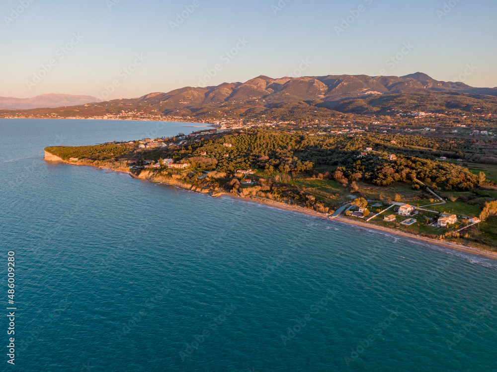 Aerial drone view of agnos beach in corfu greece with sunset