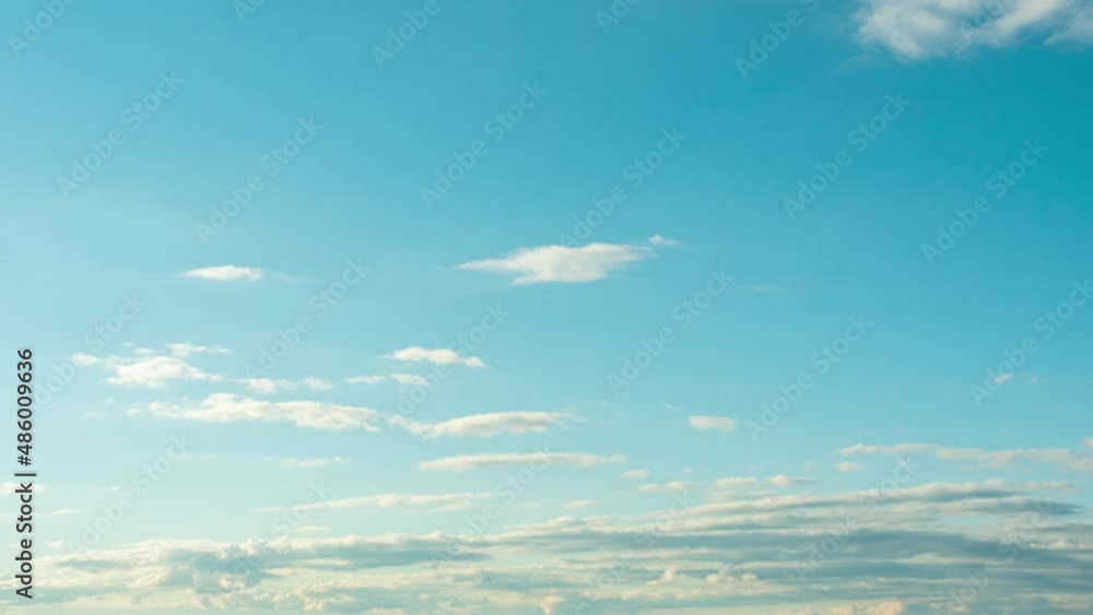 A time-lapse of fluffy clouds moving across the blue sky. A time-lapse of fluffy clouds moving across the blue sky.