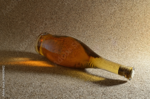 Bottle of homemade wine on a cork background.