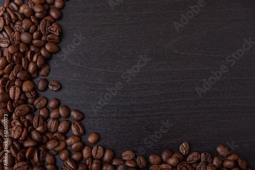 roasted coffee beans on black wood background