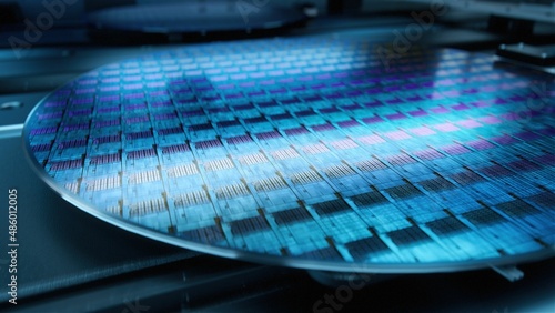 Macro Shot of Silicon Wafer During Production at Advanced Semiconductor Foundry, that produces Microchips photo