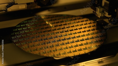 Silicon Wafer in Yellow light at Advanced Semiconductor Foundry, that produces Computer Chips. photo