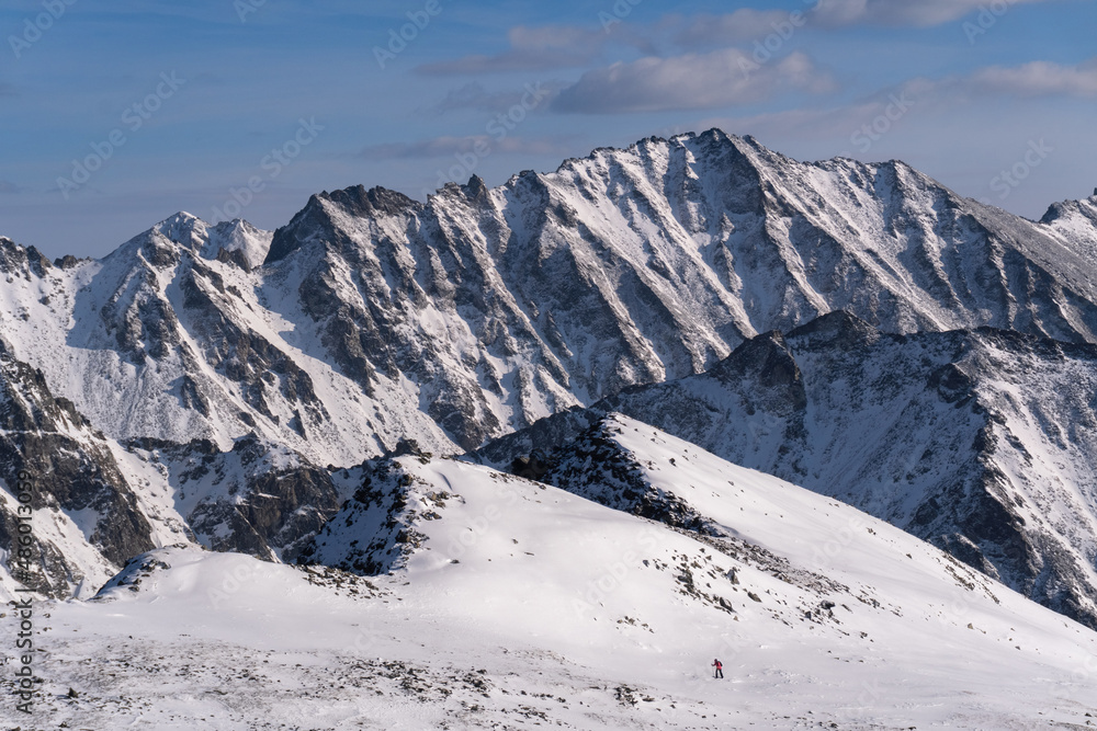 A small man against the backdrop of the huge mountains of the Eastern Sayan A small man against the backdrop of the huge mountains of the Eastern Sayan