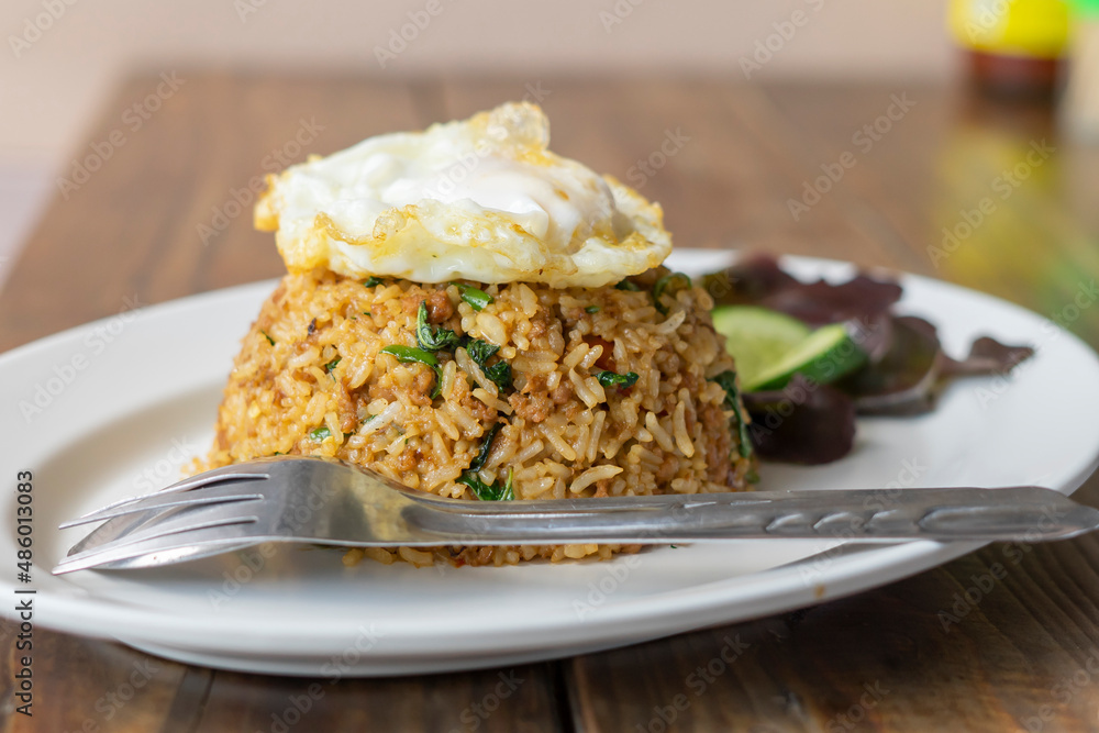 Rice topped with stir-fried pork
and basil.Thai street food.Stir fried basil. Rice topped with stir-fried pork
and basil.Thai street food.Stir fried basil.