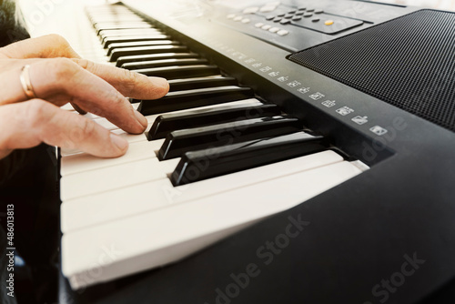 Fotografie Male hands playing electric synthesizer Digital Piano, fingers pushing keys