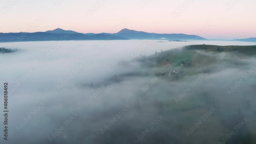 Aerial view of foggy sunrise in the mountains. Summer mountains. Aerial view of foggy sunrise in the mountains. Summer mountains.