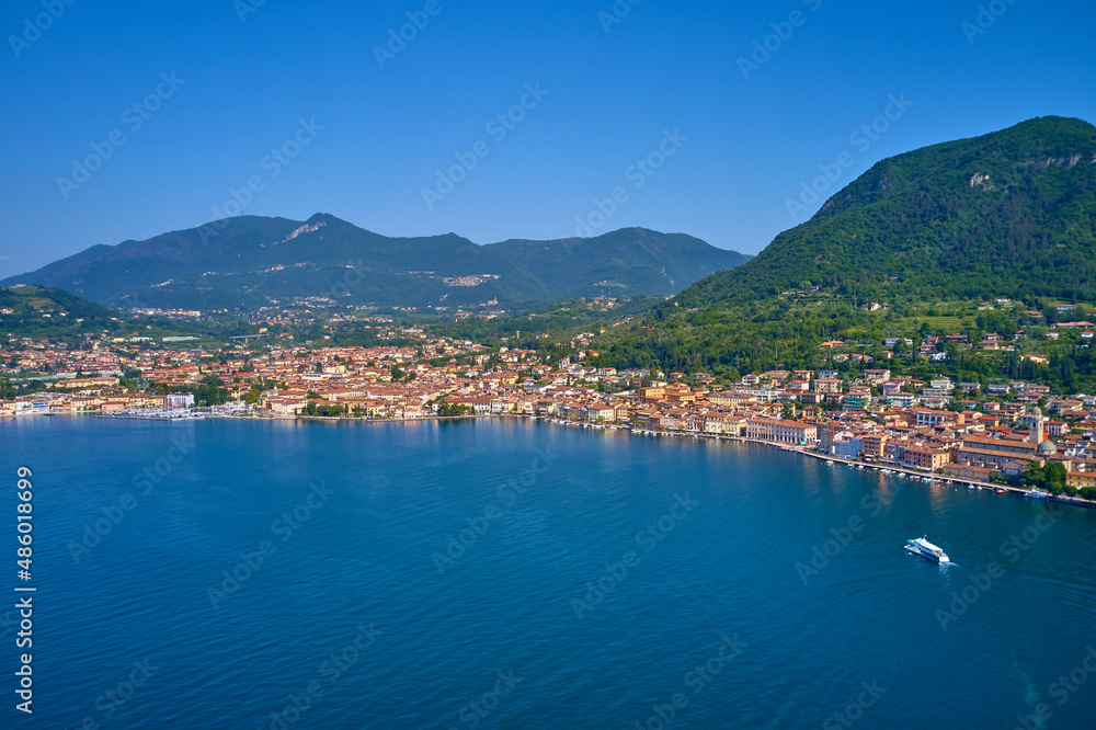 Salò on Garda Lake in the summer, little village in italy, view by Drone for your holidays in Italy. Panoramic view of the historic part of Salò on Lake Garda Italy.