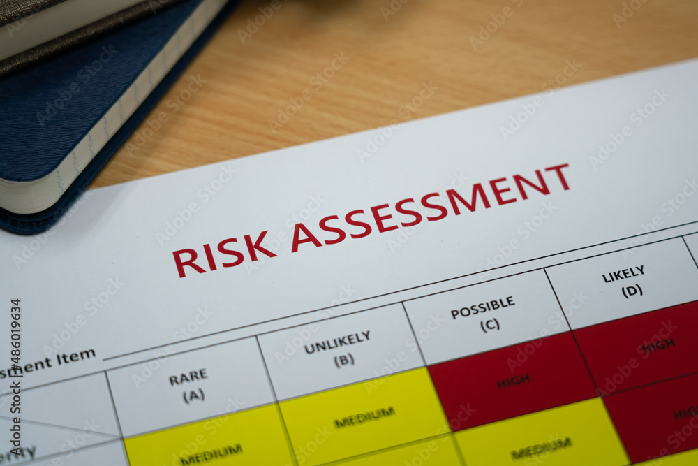 Risk assessment matrix table paperwork with severity level color for