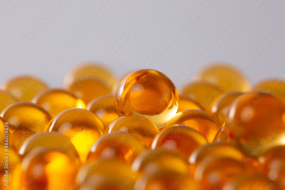 Round transparent yellow capsules with fish oil close-up Round transparent yellow capsules with fish oil close-up