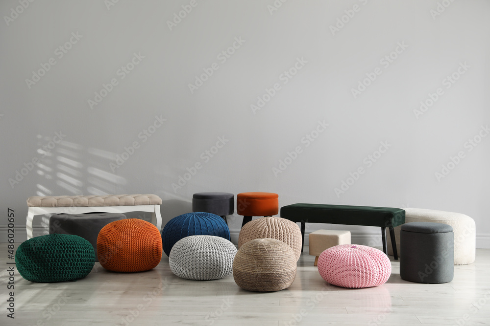 Obraz premium Many stylish different poufs and benches indoors. Home design