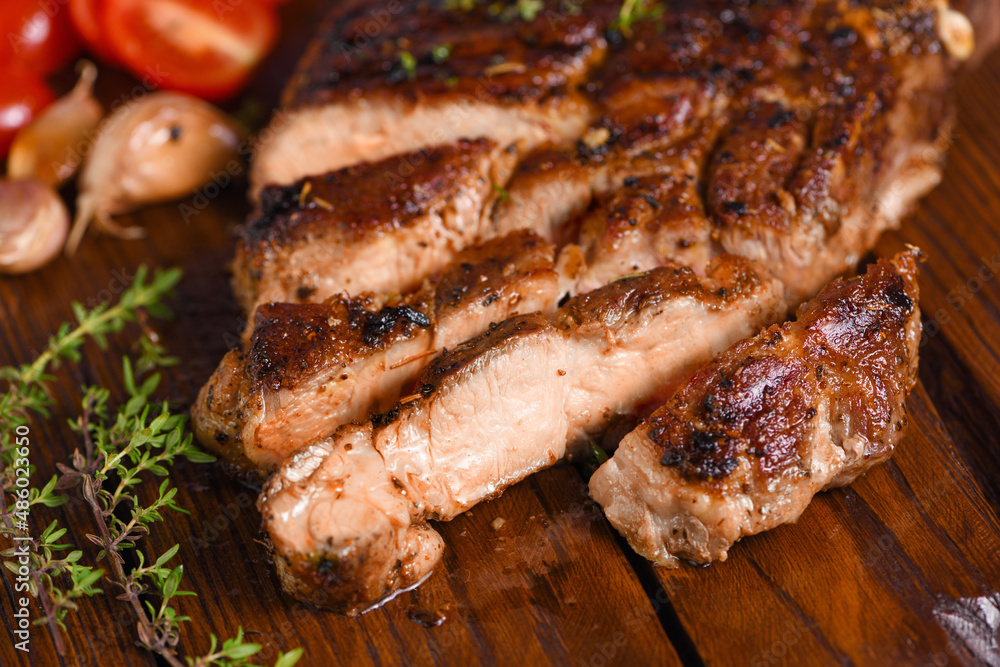 Sliced fried pork steak on a wooden board for serving