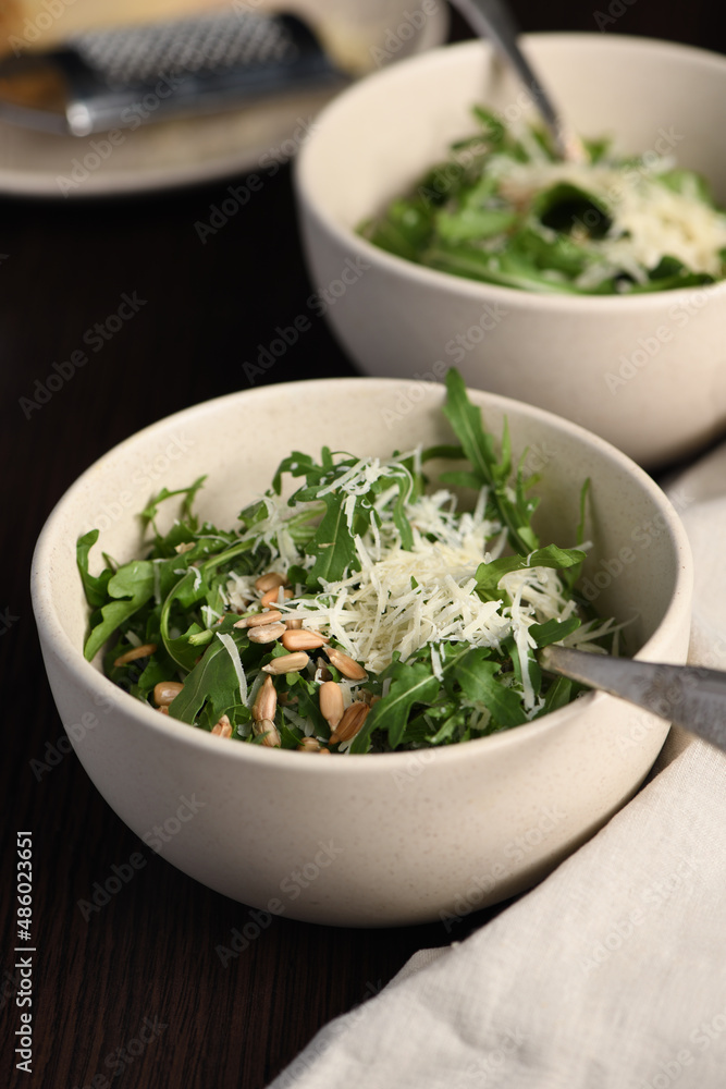 Arugula salad with sunflower kernels and sprinkled with grated parmesan Arugula salad with sunflower kernels and sprinkled with grated parmesan