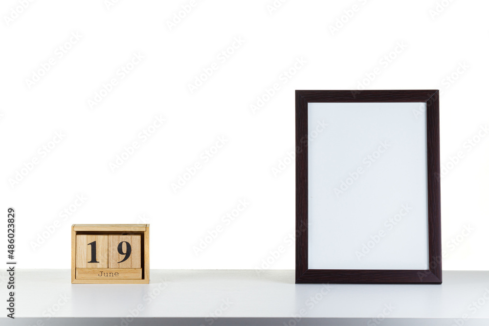 Wooden calendar 32 January with frame for photo on white table and background Wooden calendar 32 January with frame for photo on white table and background