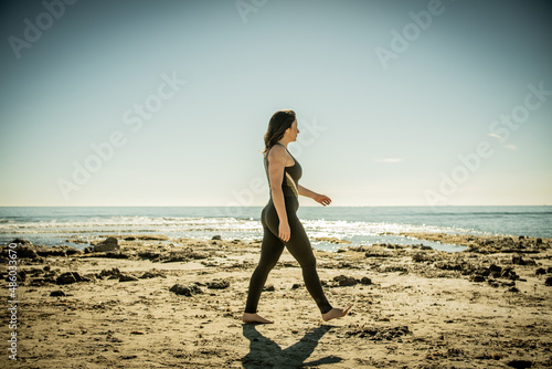 girl walking on the beach sideways