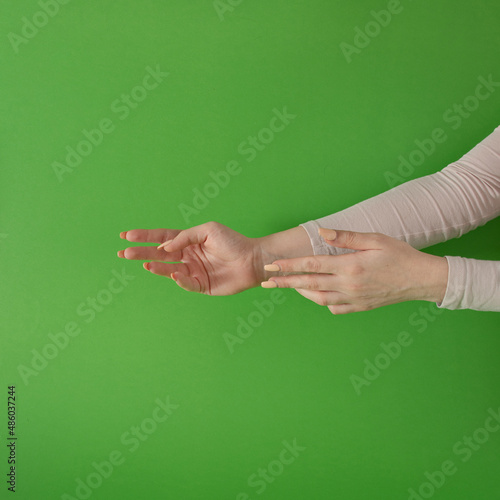 women hands against green background. modern minimalism with copyspace