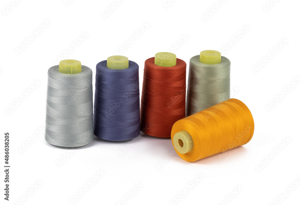Spool of sewing thread, isolated on white background. Colored yarns used by factories in the clothing industry. Threads wound on the spool. Colored reels Spool of sewing thread, isolated on white background. Colored yarns used by factories in the clothing industry. Threads wound on the spool. Colored reels