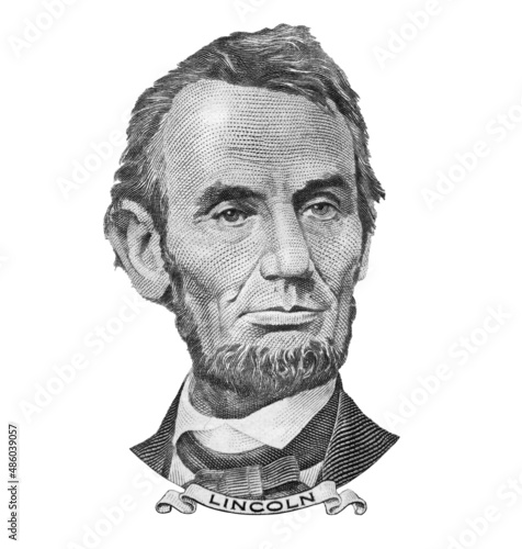 Portrait of former U.S. president Abraham Lincoln as he looks on five dollar bill obverse , isolated 