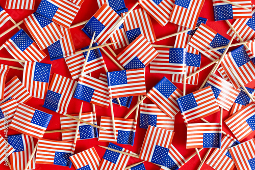 American flags flat lay on the red background. USA national day USA celebration.