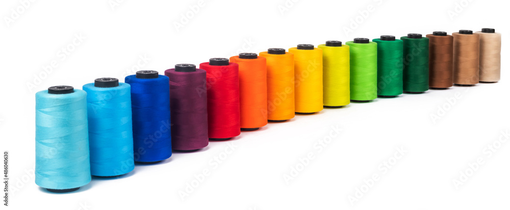 Spool of sewing thread, isolated on white background. Colored yarns used by factories in the clothing industry. Threads wound on the spool. Colored reels Spool of sewing thread, isolated on white background. Colored yarns used by factories in the clothing industry. Threads wound on the spool. Colored reels