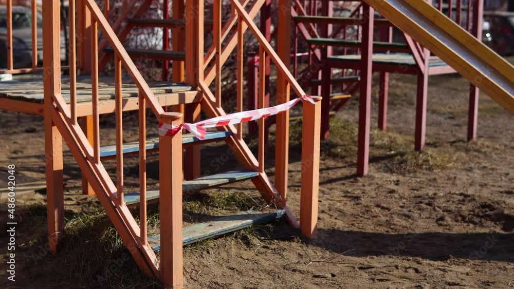 No children on the playground in the urban yard. View of a closed playground. Emergency COVID-19 restrictions. Ban on city play area. No children on the playground in the urban yard. View of a closed playground. Emergency COVID-19 restrictions. Ban on city play area.