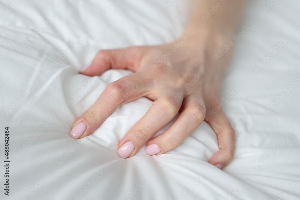 Woman hand squeezing white blanket at home closeup Stock Photo | Adobe Stock