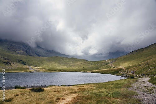 The cloud covered mountains of Great End, Broad Crag and Scafell Pike from Styhead Tarn in the Englis Lake District. UK photo