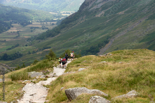  A distant group of you male adults returning from stag party on the mountains in the UK.