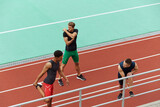 Sports men stretching before run on treadmill