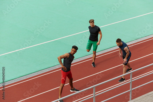 Sports men stretching before run on treadmill © Drobot Dean