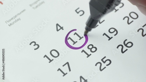 Close-up of the eleventh day of the calendar signed with a purple pen