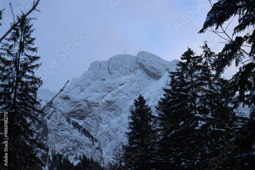 giewont peak in snowy tatras poland in winter among fir trees and pines. Heavy snowfall warning of strong wind and hurricane