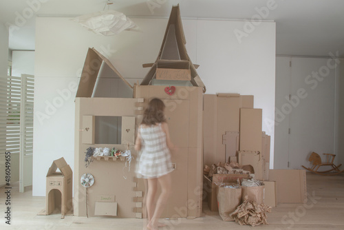 girl making a cardboard little house