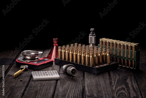 Print op canvas Reloading, ammo reloading accessories on black background, soft focus