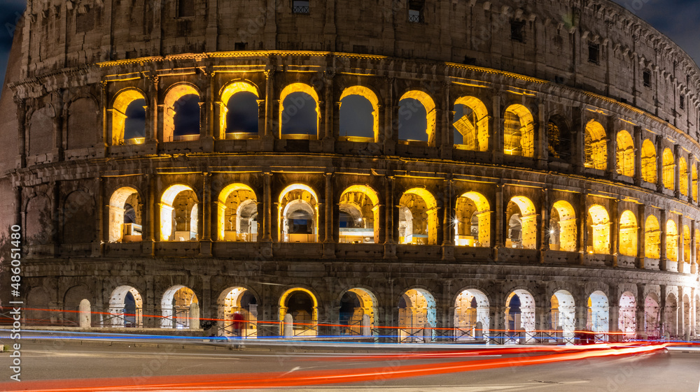 Cars light trails near the Coloseum,    Rome, Italy. Also Known As Flavian Amphitheatre In Evening Or Night Time. Famous World Landmark